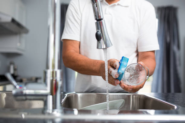 istock Senior man washing dishes in his modern, bright kitchen 1223018592