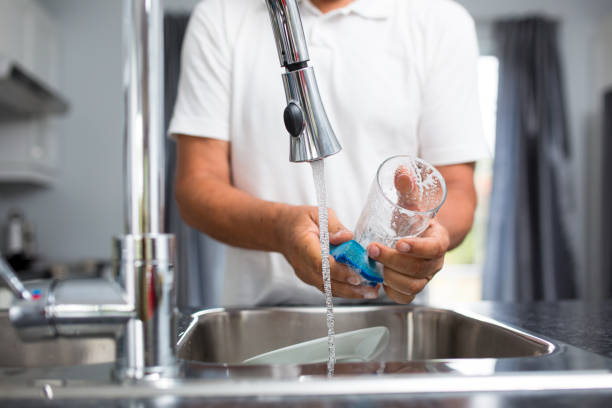 istock Senior man washing dishes in his modern, bright kitchen 1223019185