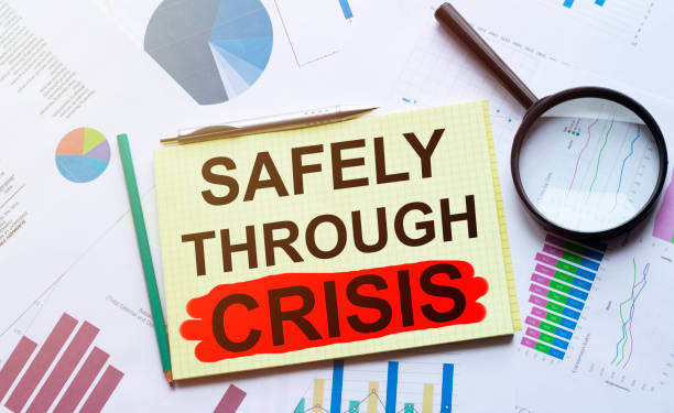 istock magnifier and paper with documents and SAFELY THROUGH CRISIS 1223020459