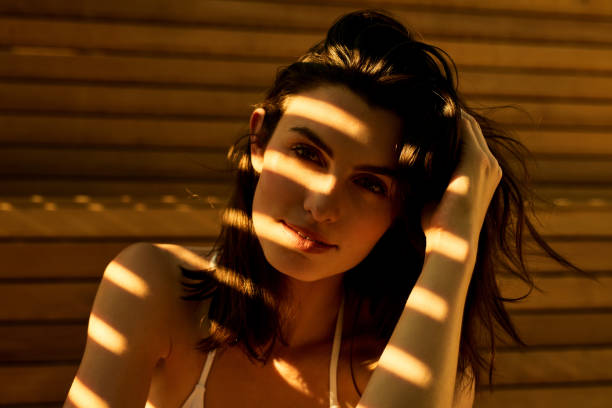 Cropped shot of a beautiful young woman posing against a wooden wall