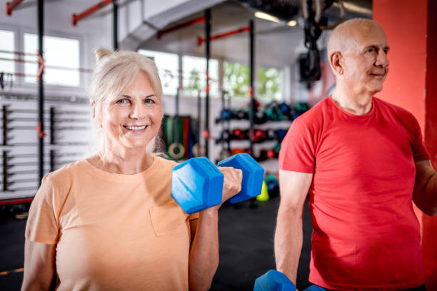 istock Senior people with dumbbells doing exercises at the gym 1223021897