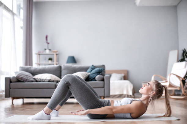 istock Slim sporty girl doing abs workout at home. 1223022001