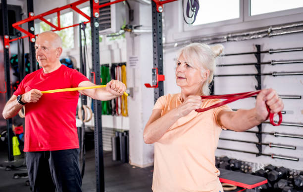 istock Senior people with resistance band doing exercises at the gym 1223022304