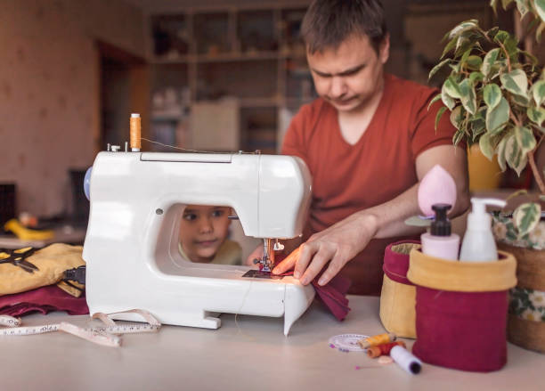 istock Man working on sewing machine and upcycling old jeans to crafted basket, zero waste home decor 1223022324