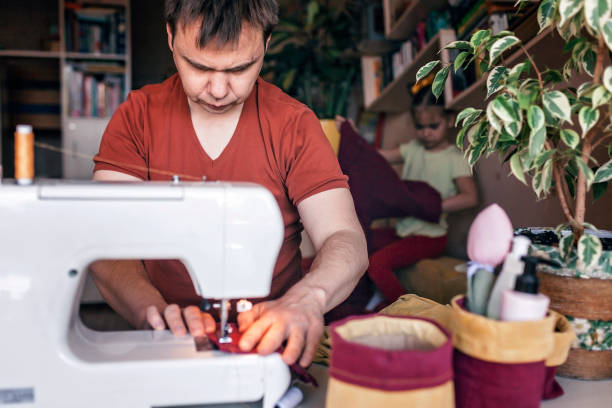 istock Man working on sewing machine and upcycling old jeans to crafted basket, zero waste home decor 1223022328