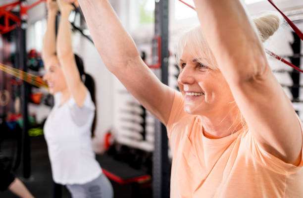 istock Senior people with trainer using resistance band doing exercises at the gym 1223022508