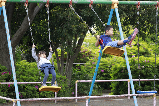 Japanese brother and sister on the swing  (10 years old boy and 5 years old girl)