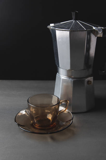 istock Italian coffee maker and empty brown glass pot on black background, morning coffee ritual, wake up, espresso, brewing coffee 1223025863