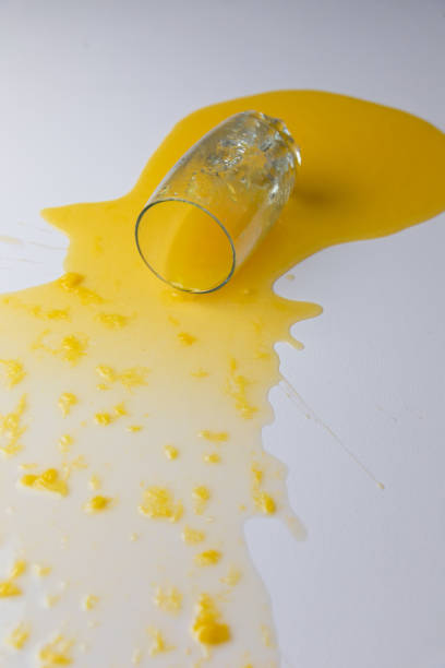 istock Fresh Orange juice spilled on a white table, with pulp 1223026672