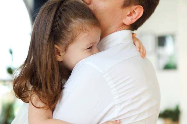 istock Adorable little daughter embracing father 1223026936