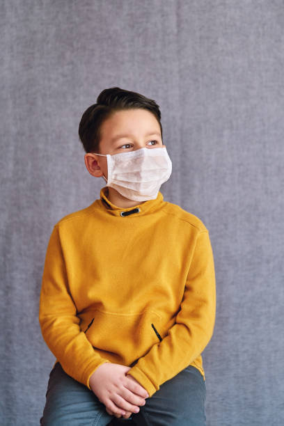 istock 6-7 years old child wearing surgical mask for prevention. 1223027035