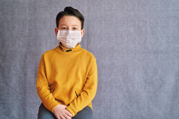 istock 6-7 years old child wearing surgical mask for prevention. 1223027207