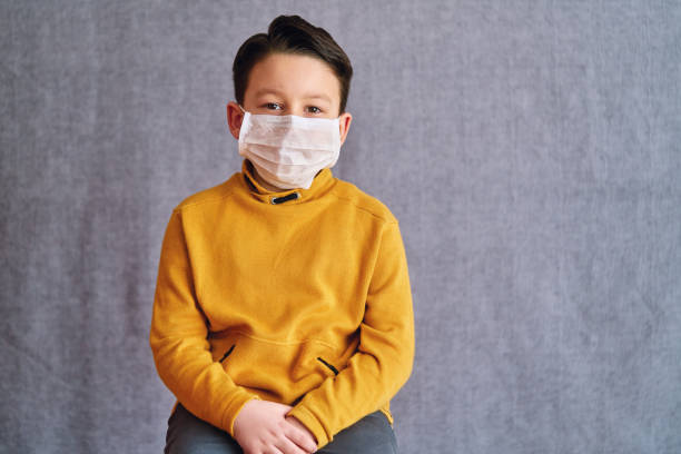 istock 6-7 years old child wearing surgical mask for prevention. 1223027414