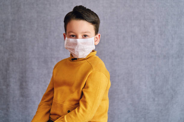 istock 6-7 years old child wearing surgical mask for prevention. 1223028481