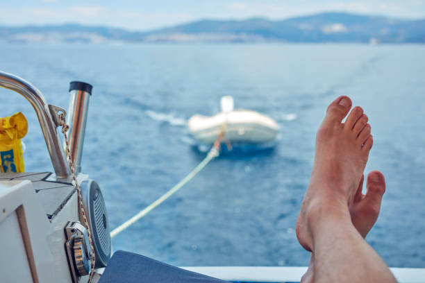 Man enjoying calm sea on a sailing boat.