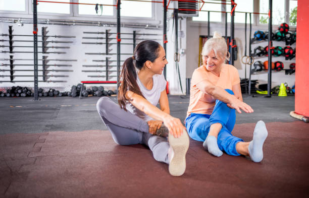 istock Senior woman workout with trainer at the gym 1223028618