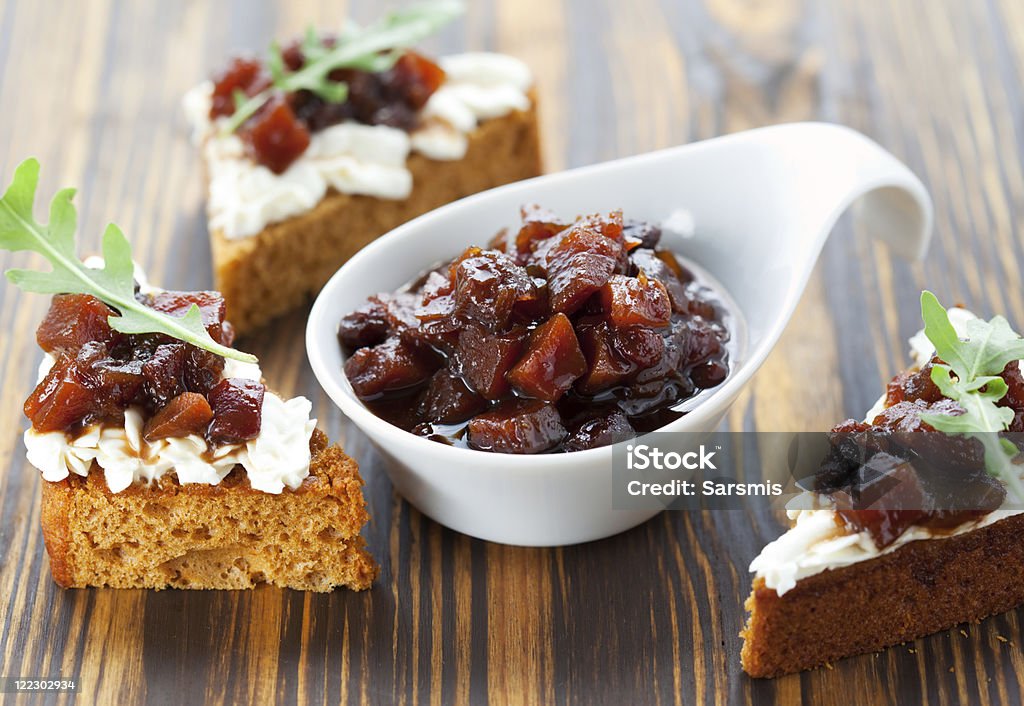 Pumpkin and tomato chutney Pumpkin and tomato chutney on pumpkin bread with soft cheese Appetizer Stock Photo