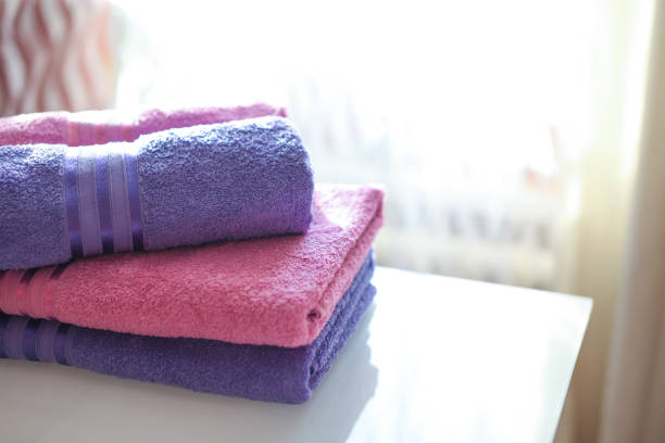 istock folded pink and purple towels 1223031528