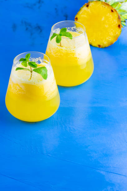 istock Pineapple cocktail on a blue background. Cold pineapple cocktail with mint. Summer tropical cocktail. Healthy drink. Copy space 1223032670