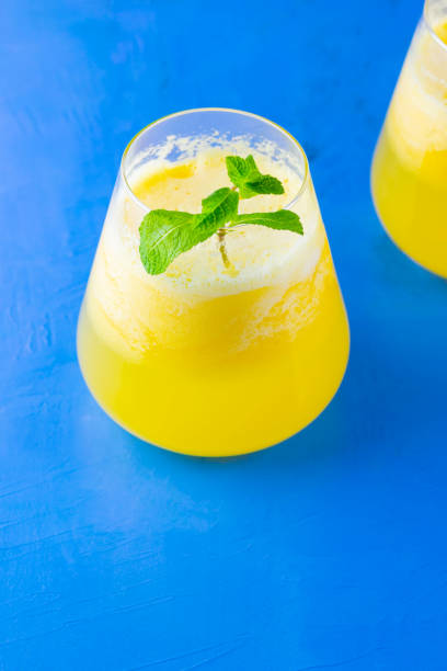 istock Pineapple cocktail on a blue background. Cold pineapple cocktail with mint. Summer tropical cocktail. Healthy drink. Copy space 1223032697