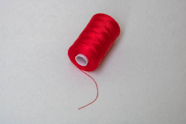 istock Red spool of sewing thread isolated, close up. 1223033996