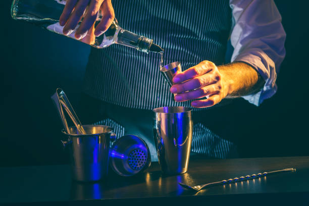 istock Bartender pouring vodka into cocktail measuring cup 1223034380