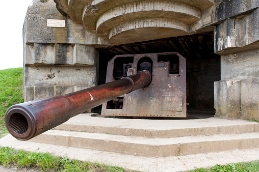 Bomb shelter with German long range artillery gun from world war 2 in Longues-sur-Mer in Normandy. This site was captured on June 7, 1944 by the British Devonshire Regiment.