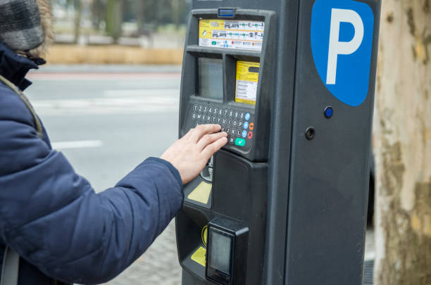 istock Man pays for parking the car using the parking machine 1223036891