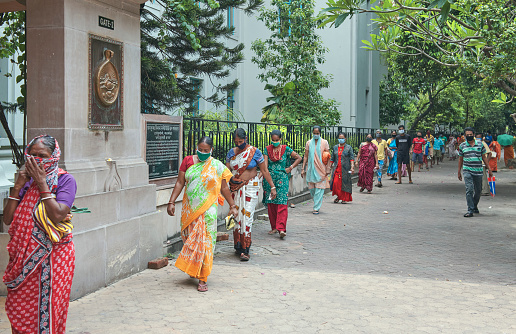 People seen waiting in queue to collect everyday essentials from Ramakrishna Mission Golpark, as part of mission's social & humanitarian work during lockdown in Kolkata.\n\nPhoto taken at Ramakrishna Mission Institute of Culture, Golpark, Kolkata on 05/05/2020.
