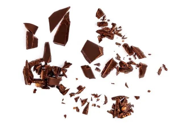 Falling Chocolate pieces and  shavings  isolated on white background"n