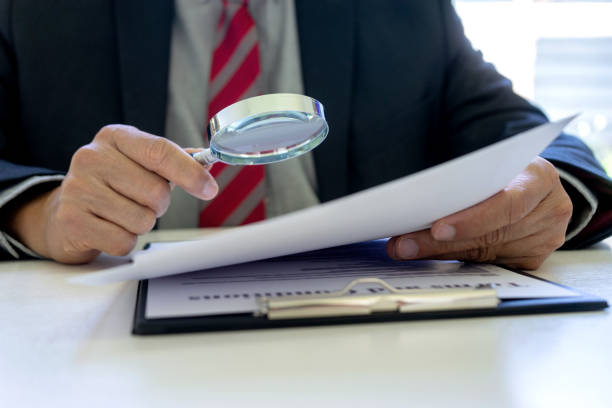 Lawyer or judge use magnifier glass look to the paper Lawyer or judge use magnifier glass look to the paper for inspection examination to the law case supreme court justice photos stock pictures, royalty-free photos & images