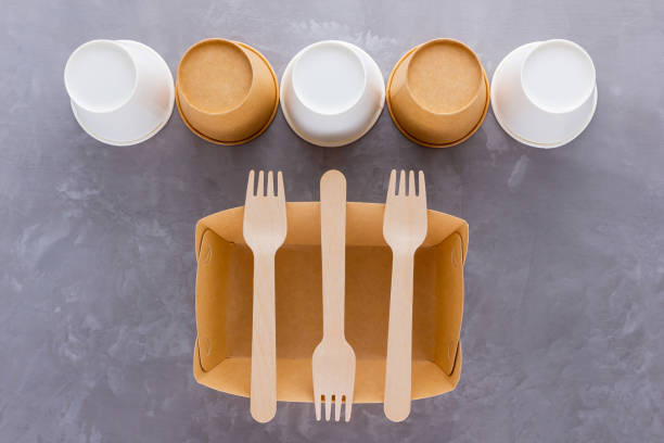 istock Zero waste. Disposable tableware. Eco-friendly disposable utensils made of bamboo wood and paper on a gray background. Paper cups, fast food containers and bamboo wooden cutlery 1223039338