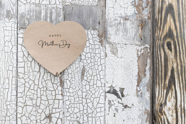 istock Happy Mother's Day written on a heart shaped card on a rustic wall 1223040816