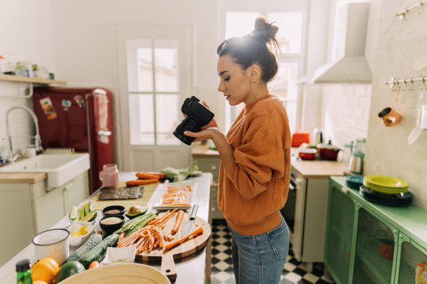 istock Young woman photographing sushi making process 1223041045