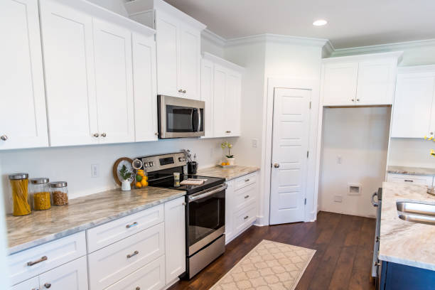 istock New construction modern kitchen with white cabinets and hardwood floors 1223041405