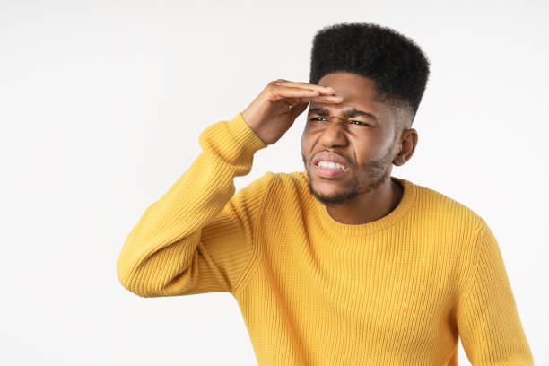 istock Young man looking far away with hand to look something over isolated white background 1223042373