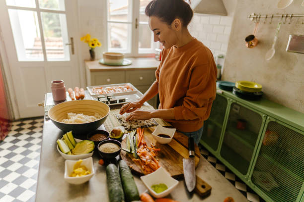 istock Millennial woman making sushi 1223042578