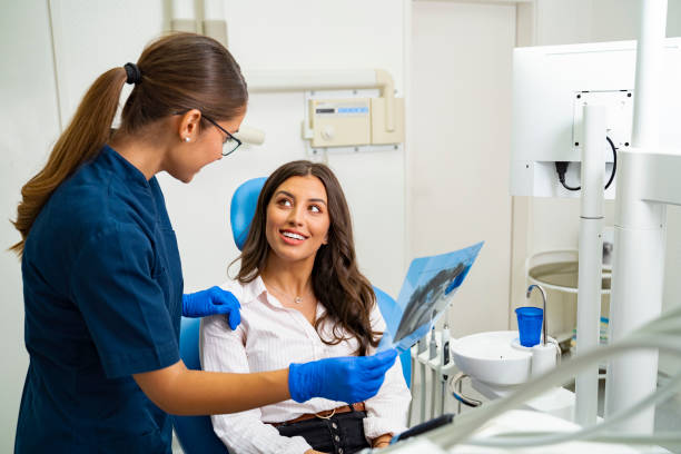 Happy patient in dental clinic relived that x-ray result is good Happy patient in dental clinic relived that x-ray result is good, looking at doctor from the chair, relieved relived stock pictures, royalty-free photos & images