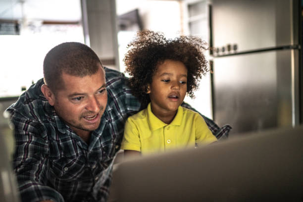 istock Father and son using laptop at home 1223043811