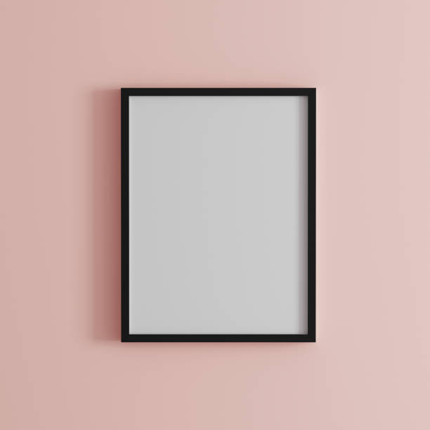 istock blank frame on light pink wall mock up, vertical black poster frame on wall,  picture frame isolated on a wall, mock up for picture or photo frame,  empty frame on bright wall, 3d render 1223044157