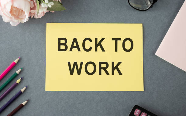 istock Back to work inscription, glasses, notebook and pen on a yellow background. Gray background, copy space, top view, flat lay. 1223044223