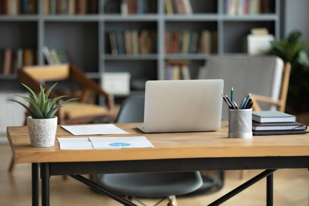istock Wooden work desk with laptop and documents, modern interior 1223044290