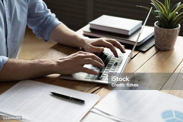 Close Up Businessman Using Laptop Sitting At Work Desk Stock Photo - Download Image Now