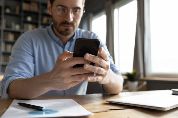 istock Close up focused businessman looking at smartphone screen 1223044300