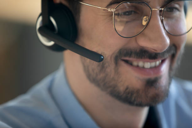 istock Close up smiling friendly man wearing headset with microphone 1223044319