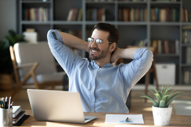 istock Smiling businessman leaning back in chair, dreaming about future 1223044322