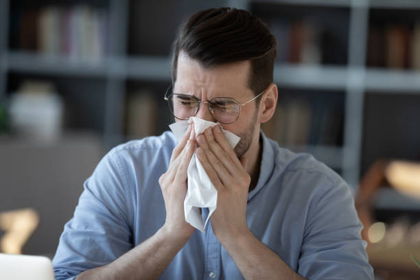 istock Close up unhealthy businessman blowing running nose, using napkin 1223044357