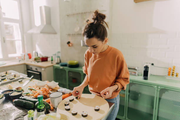 istock Young woman arranging sushi 1223044975
