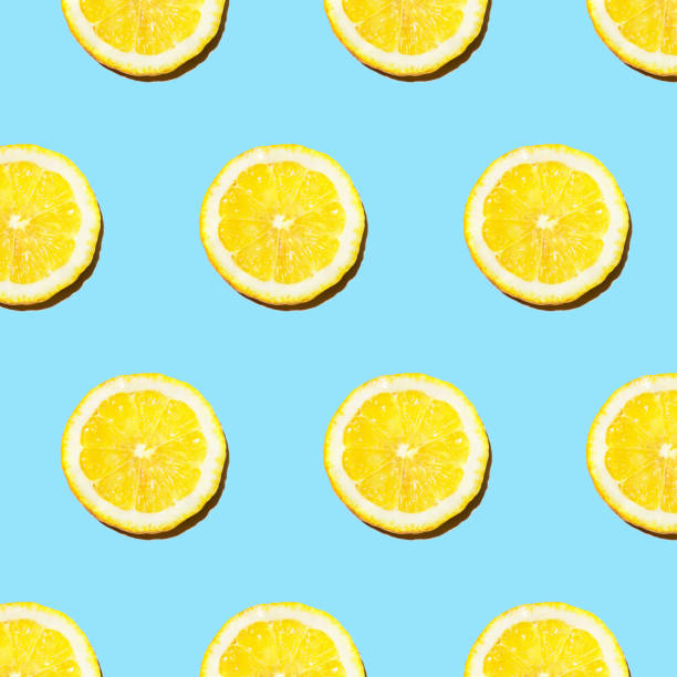 istock Trendy sunlight Summer pattern made with yellow lemon slice on bright light blue background. summer concept. 1223047277