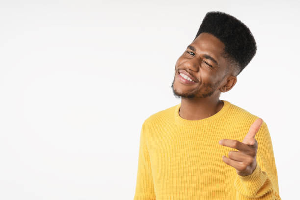 istock Portrait of young man pointing with his finger cool expression against white background 1223048036